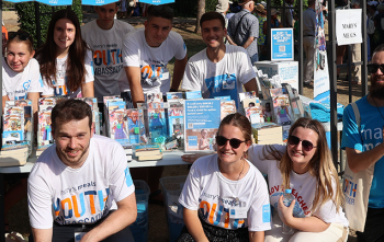 Image of Mary's Meals supporters posing with Mary's Meals props. 