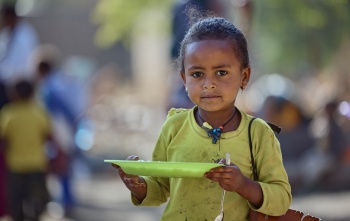 girl eating Mary's Meals in Ethiopia