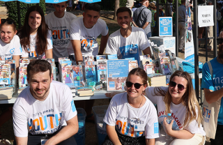 Image of Mary's Meals supporters posing with Mary's Meals props.