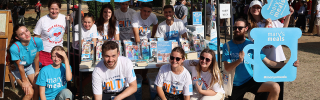 Image of Mary's Meals supporters posing with Mary's Meals props.