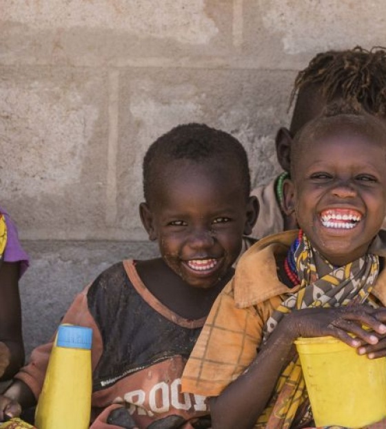 A group of children sit together to eat at school.
